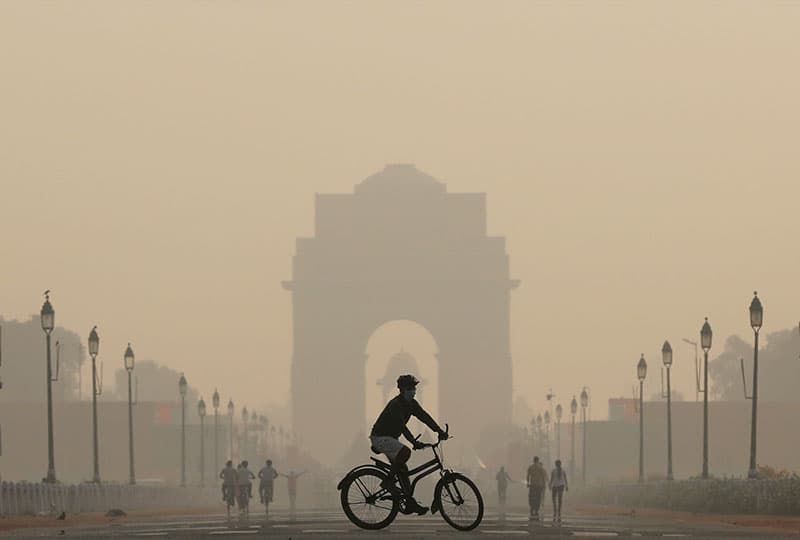 A view of the India Gate in New Delhi, India, with smog present